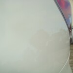 Before and after photographs of a damaged white Subaru that was repaired by Elite Paint & Body Shop in West Palm Beach, Florida